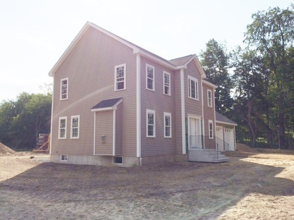 Lot 2 Maple Avenue Rutland, MA 01543 - Photo 4 of 8 a front view of a house with a yard and garage