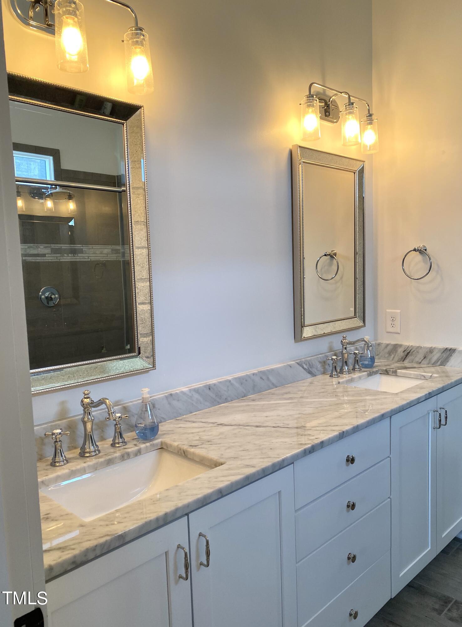 454 Waterville Street Raleigh, NC 27603 - Photo 15 of 25 a bathroom with a granite countertop sink and a mirror