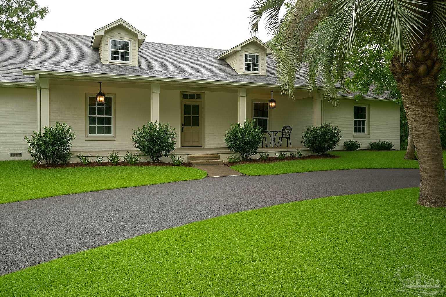 4067 Parkview Street Pace, FL 32571 - Photo 2 of 46 a front view of a house with a yard and palm trees