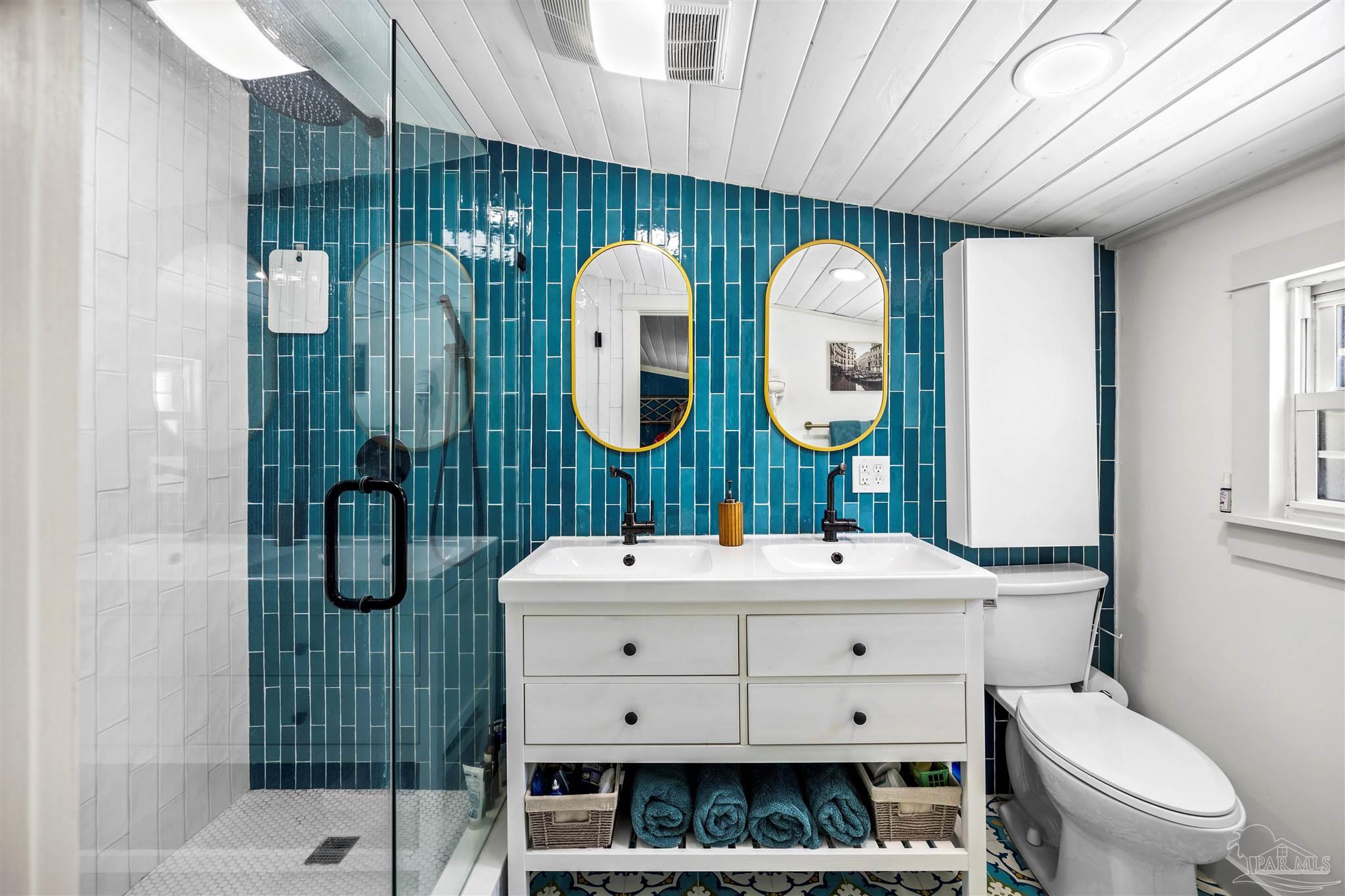 4067 Parkview Street Pace, FL 32571 - Photo 27 of 46 a bathroom with a sink mirror and toilet