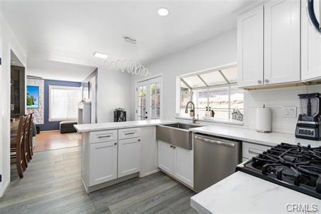 1358 Leopard Court Palmdale, CA 93551 - Photo 3 of 11 a kitchen with a sink a stove and cabinets