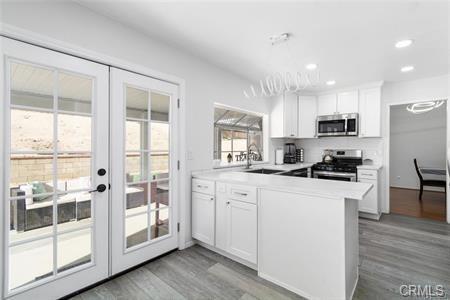 1358 Leopard Court Palmdale, CA 93551 - Photo 4 of 11 a kitchen with stainless steel appliances granite countertop a stove a sink and a refrigerator
