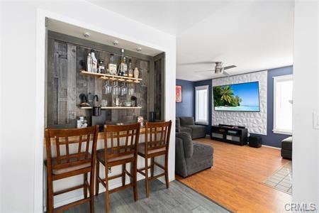 1358 Leopard Court Palmdale, CA 93551 - Photo 7 of 11 a living room with furniture wooden floor and a flat screen tv