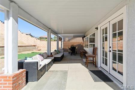 1358 Leopard Court Palmdale, CA 93551 - Photo 8 of 11 a living room with furniture floor to ceiling windows and wooden floor