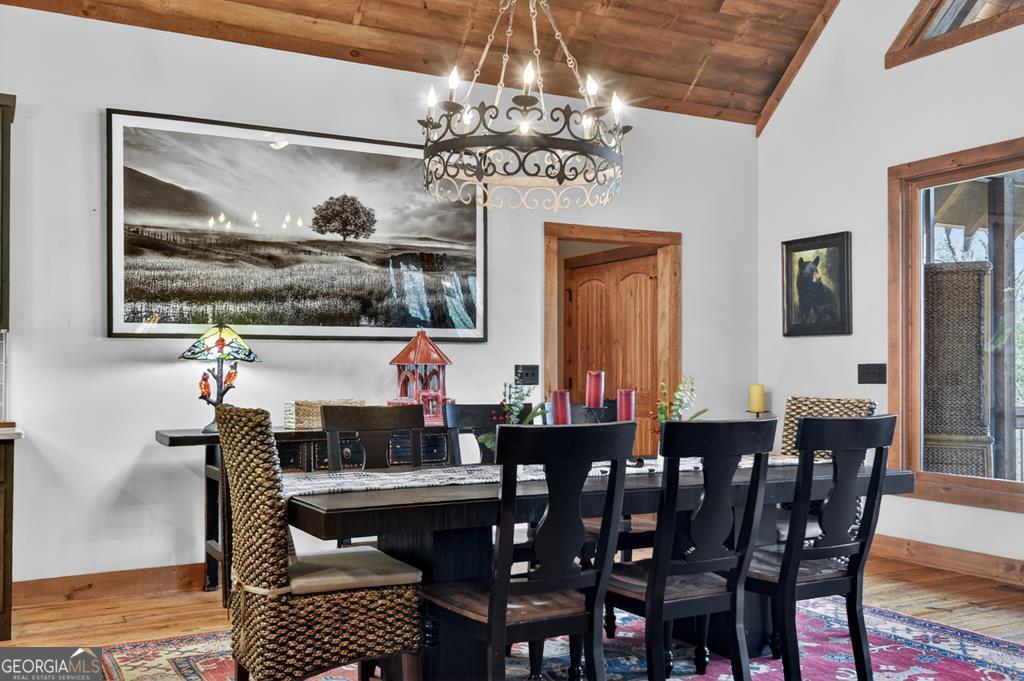 366 Shepherds Lane Morganton, GA 30560 - Photo 23 of 79 a living room with furniture a chandelier and a dining table
