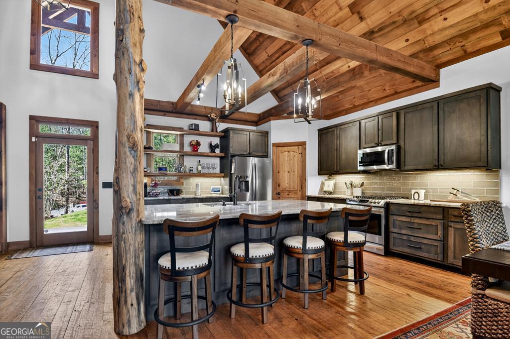366 Shepherds Lane Morganton, GA 30560 - Photo 25 of 79 a dining area with stainless steel appliances kitchen island granite countertop a table chairs and wooden floor