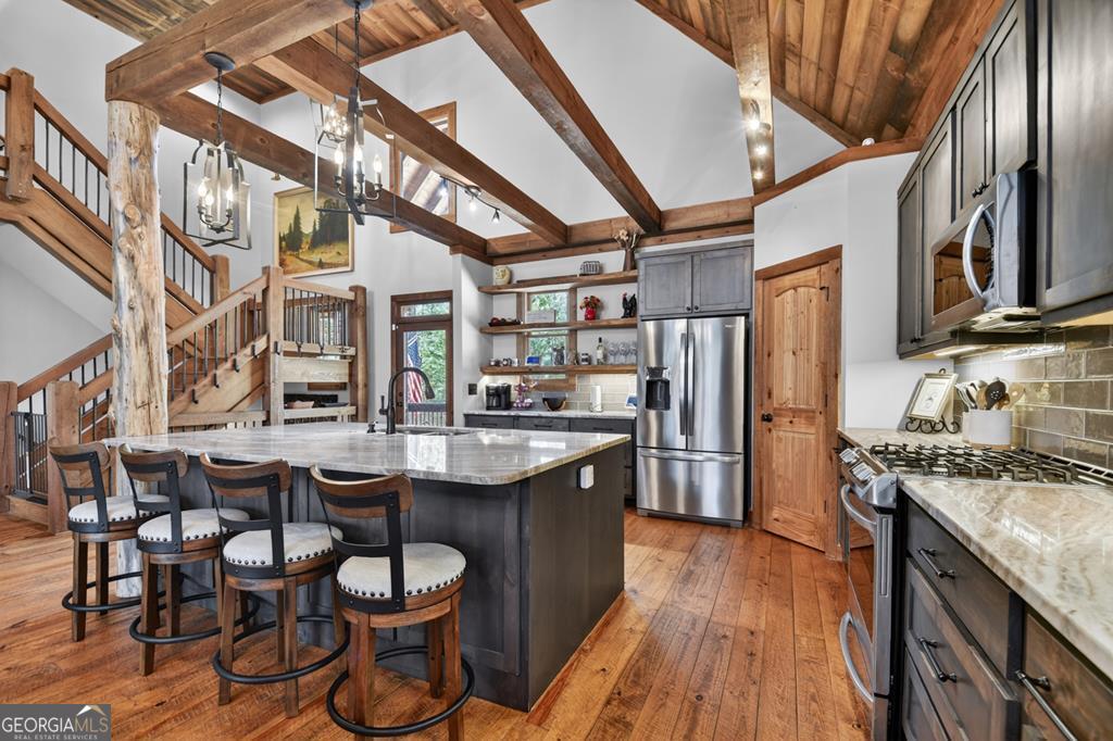 366 Shepherds Lane Morganton, GA 30560 - Photo 27 of 79 a kitchen with stainless steel appliances granite countertop a stove a sink dishwasher and cabinets with wooden floor