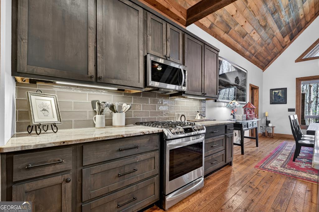 366 Shepherds Lane Morganton, GA 30560 - Photo 30 of 79 a kitchen with stainless steel appliances granite countertop wooden cabinets a stove top oven a sink and dishwasher