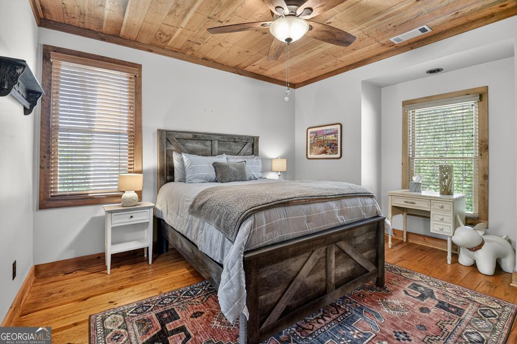 366 Shepherds Lane Morganton, GA 30560 - Photo 33 of 79 a bedroom with a bed and a chandelier