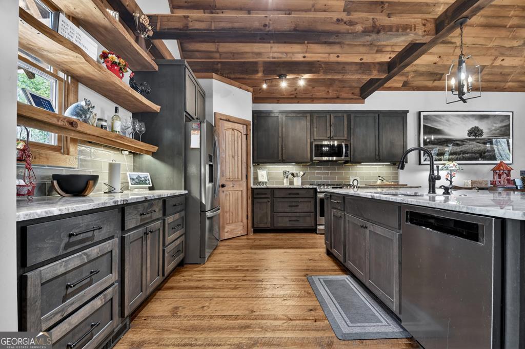 366 Shepherds Lane Morganton, GA 30560 - Photo 36 of 79 a large kitchen with stainless steel appliances wooden cabinets and a stove top oven