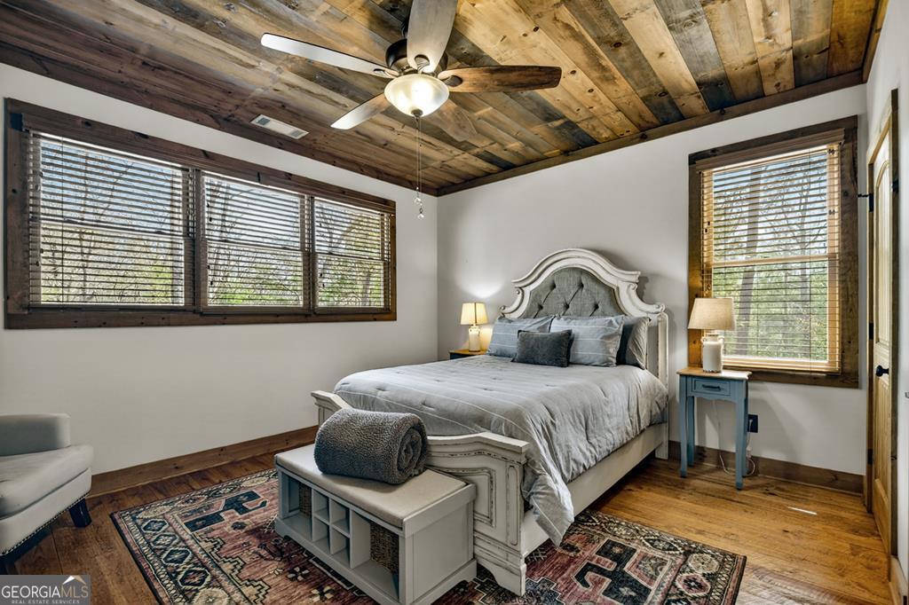 366 Shepherds Lane Morganton, GA 30560 - Photo 52 of 79 a bedroom with a bed and wooden floor