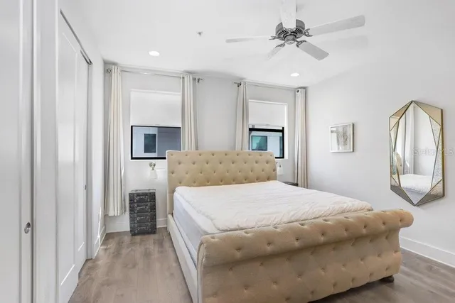 a living room with a bed furniture and a chandelier
