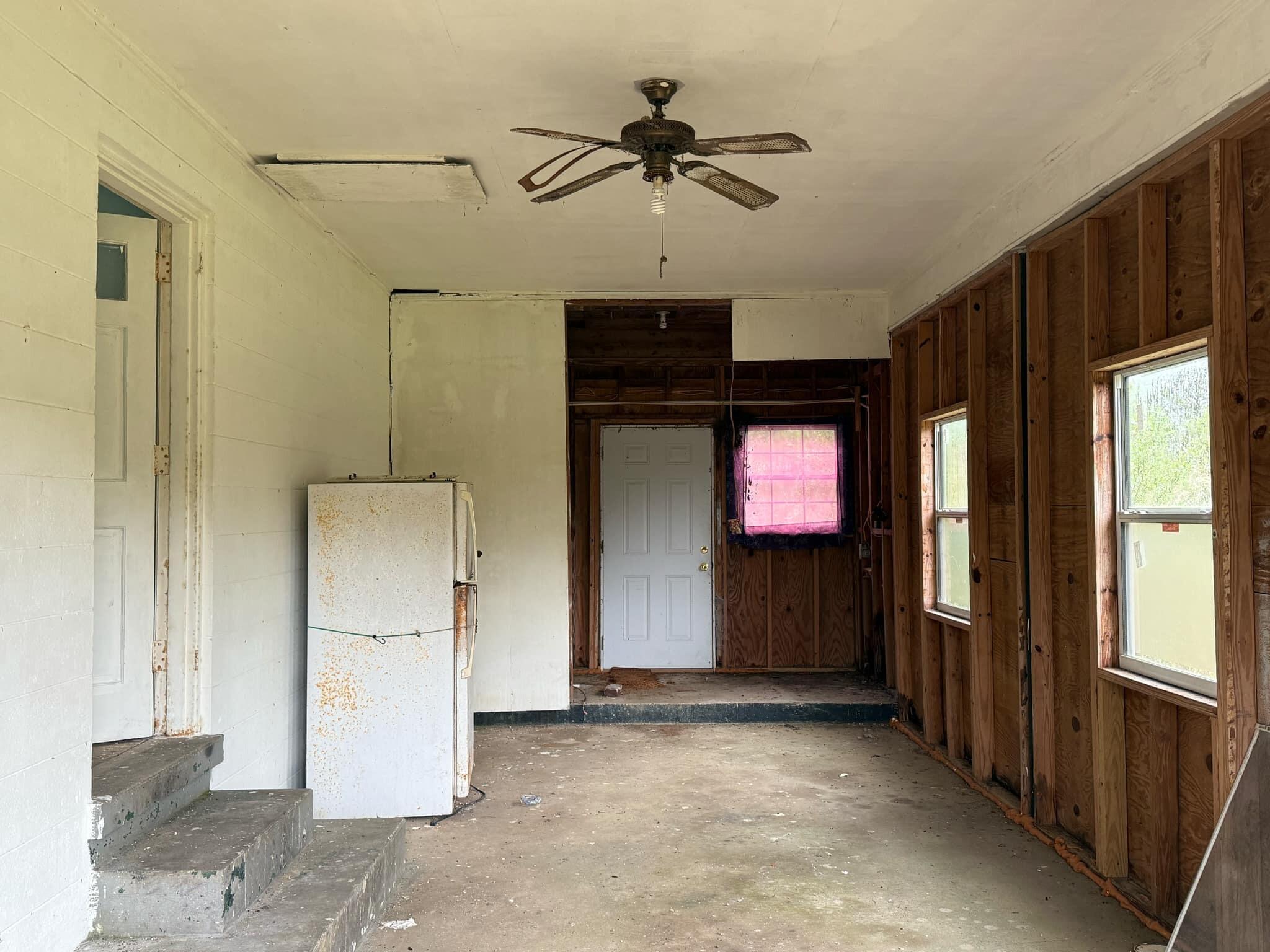 1951 Caton Road Florala, AL 36442 - Photo 11 of 34 a view of a hallway with a cabinet and a chandelier