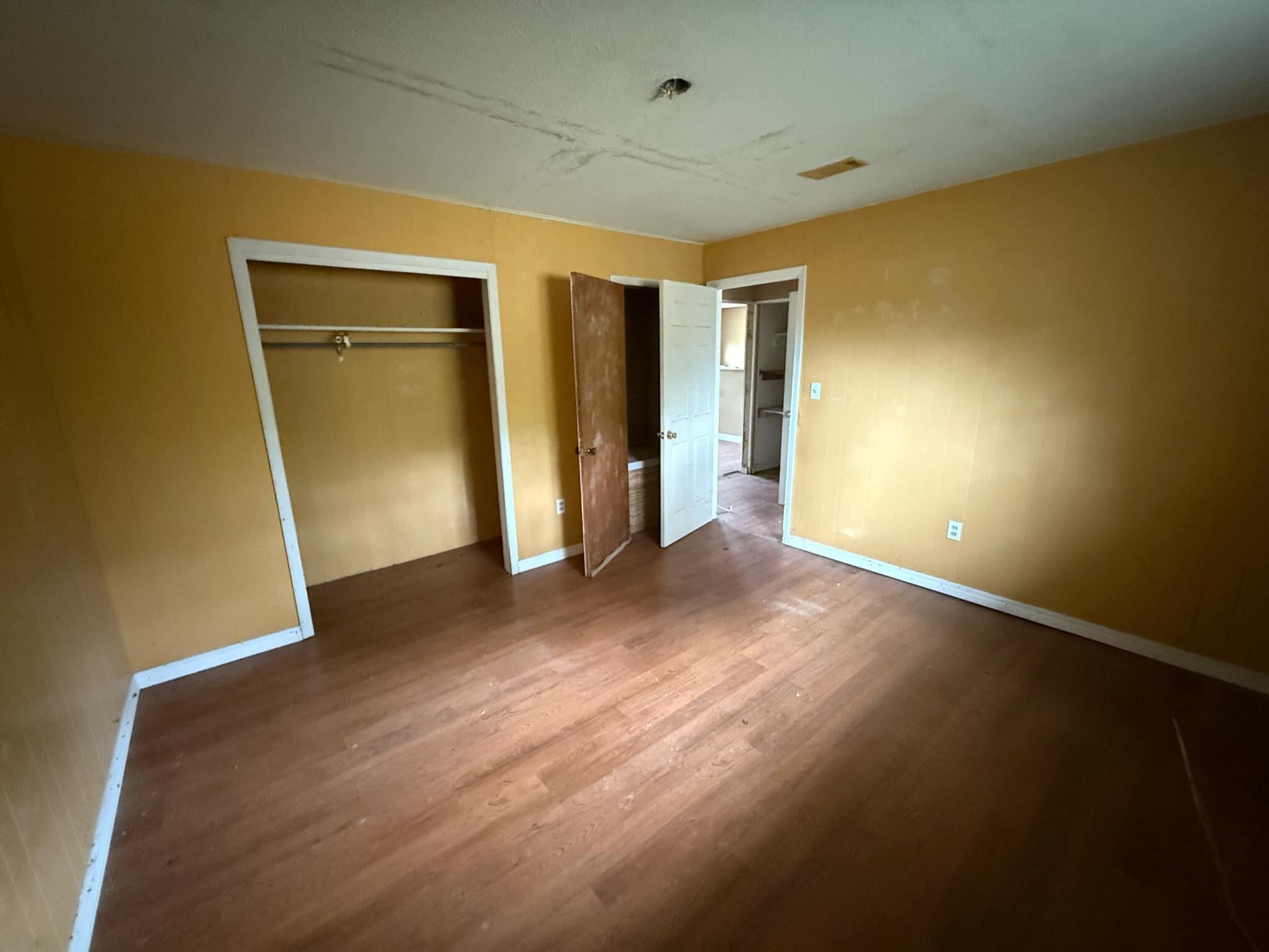 1951 Caton Road Florala, AL 36442 - Photo 19 of 34 an empty room with closet and wooden floor