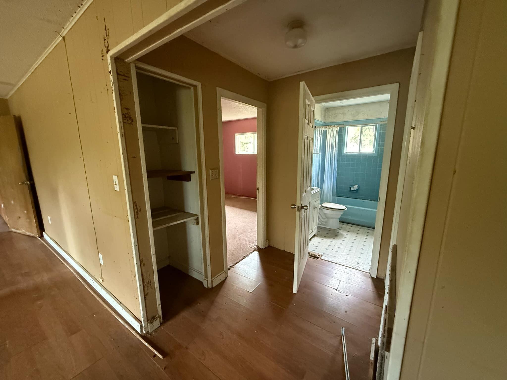 1951 Caton Road Florala, AL 36442 - Photo 29 of 34 a view of a hallway with wooden floor and a living room