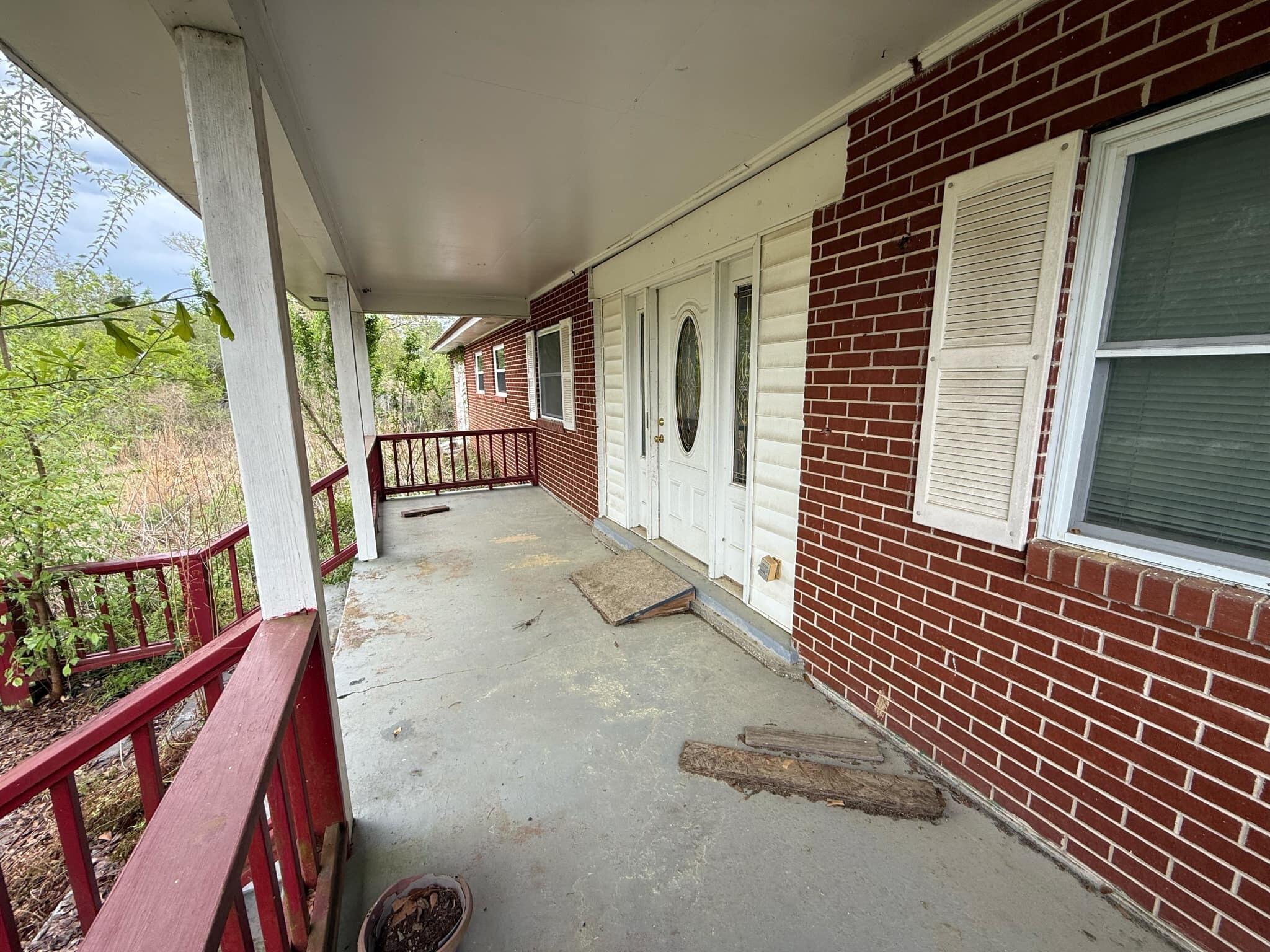 1951 Caton Road Florala, AL 36442 - Photo 4 of 34 a view of a porch with wooden floor and stairs