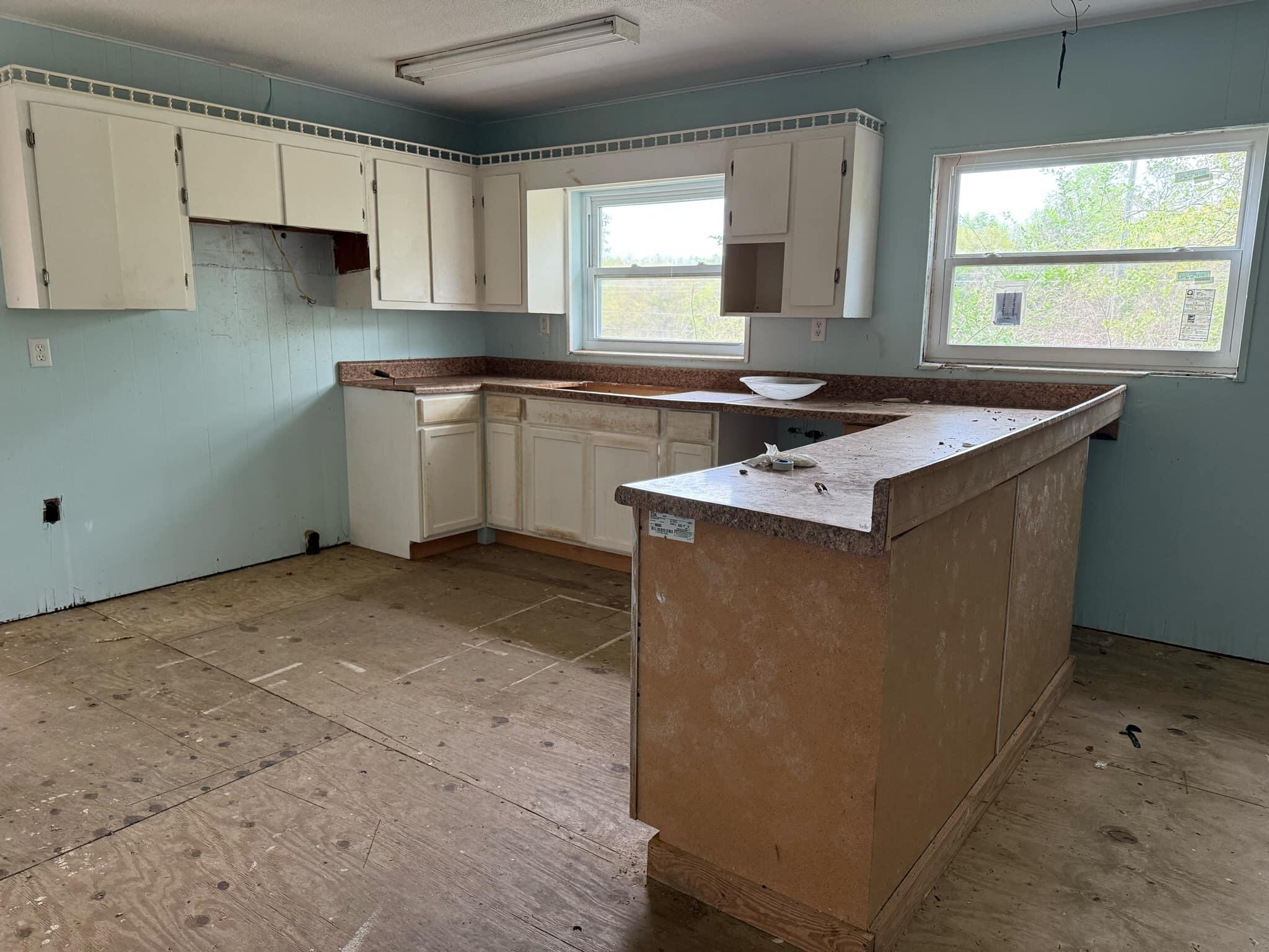 1951 Caton Road Florala, AL 36442 - Photo 9 of 34 a kitchen with a sink window and cabinets