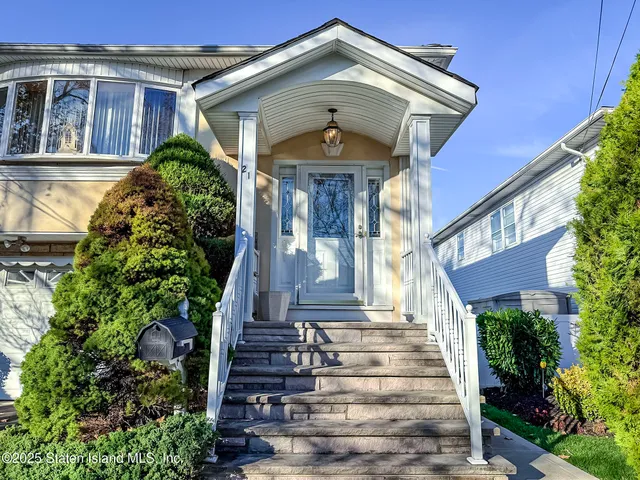 a front view of a house with a garden