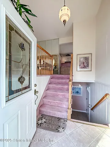 a living room with furniture dining area and a chandelier