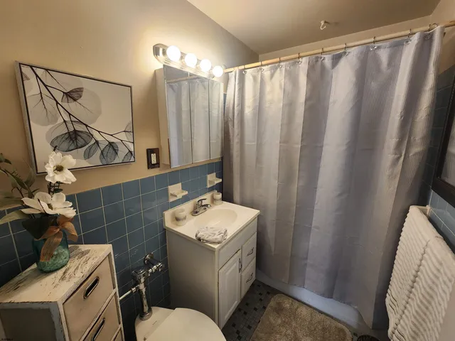 a bathroom with a sink a toilet and a mirror