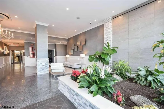 a lobby with furniture and potted plants
