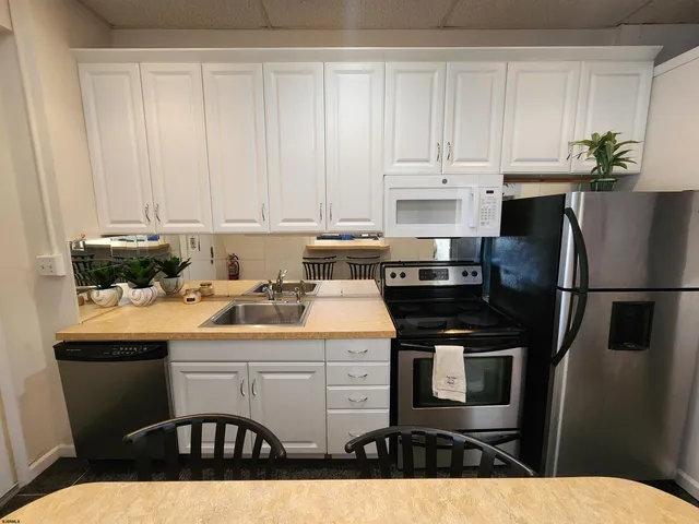 a kitchen with a sink a stove and refrigerator