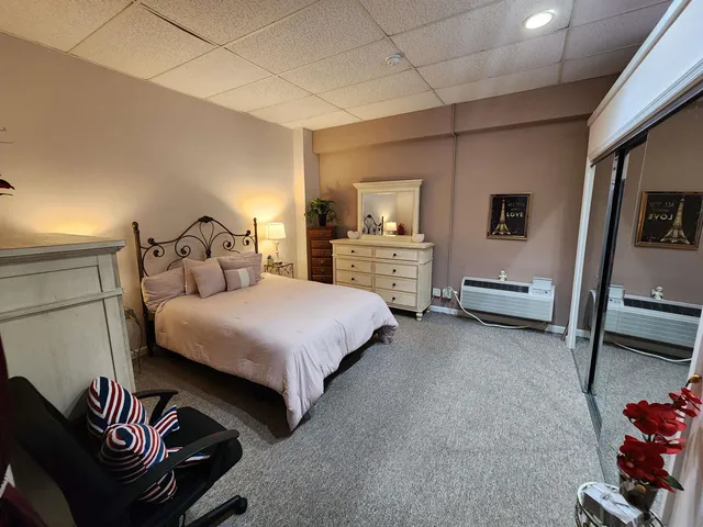 a bedroom with furniture and a flat screen tv