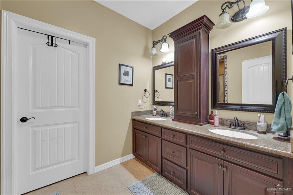1605 East 30th Street Mission, TX 78574 - Photo 9 of 16 Bathroom featuring double vanity and light tile patterned floors
