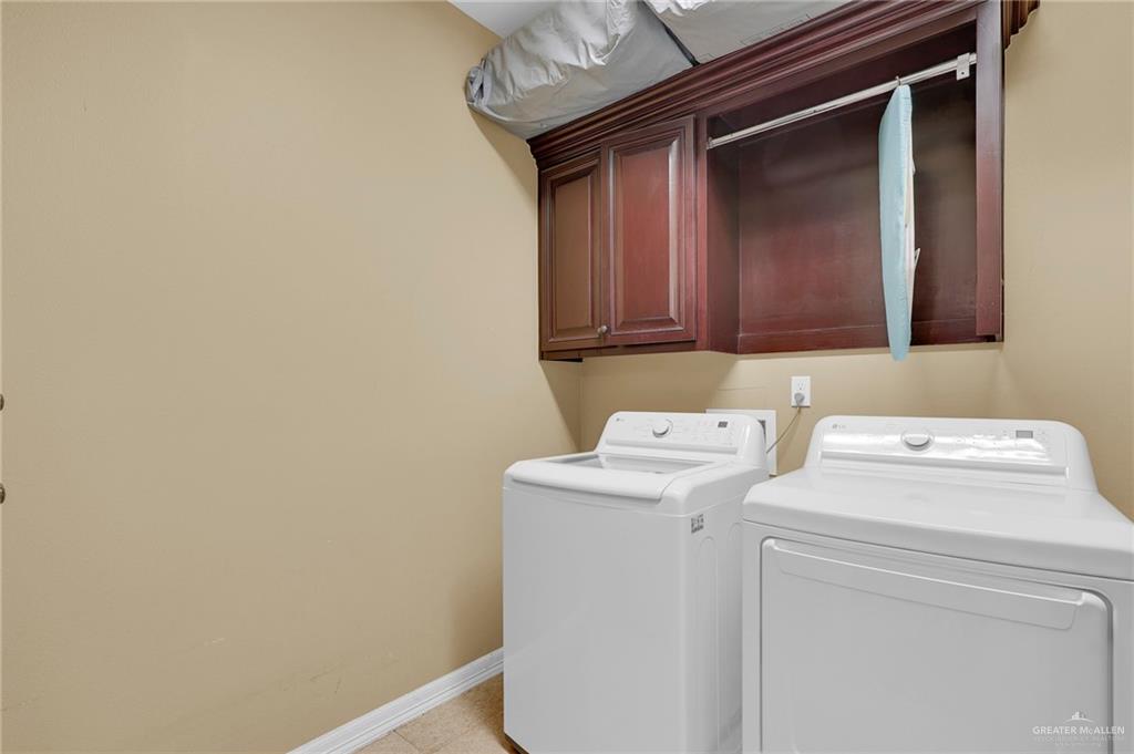 1605 East 30th Street Mission, TX 78574 - Photo 10 of 16 Washroom featuring washing machine and clothes dryer and cabinet space