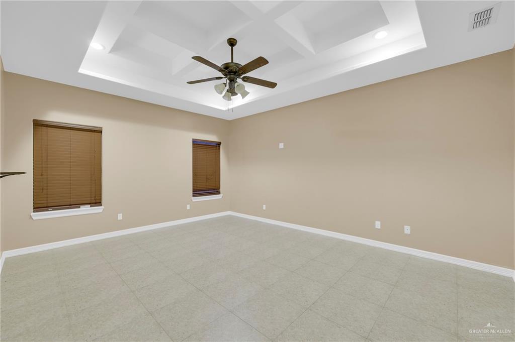 1605 East 30th Street Mission, TX 78574 - Photo 5 of 16 Spare room featuring coffered ceiling, a ceiling fan, and beam ceiling