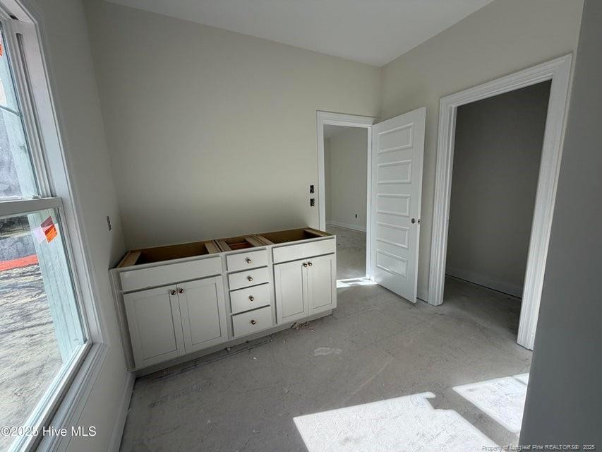 2177 Airport Road Whispering Pines, NC 28327 - Photo 9 of 15 a room with white cabinets and window
