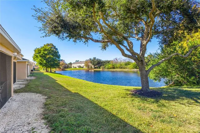 a view of yard with swimming pool and green space