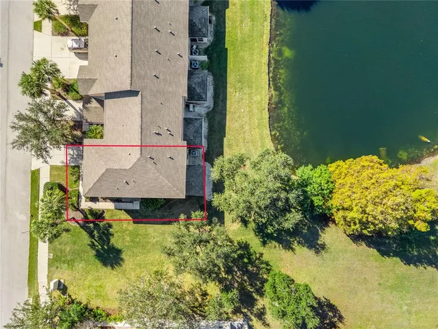 an aerial view of a house with a yard basket ball court and outdoor seating