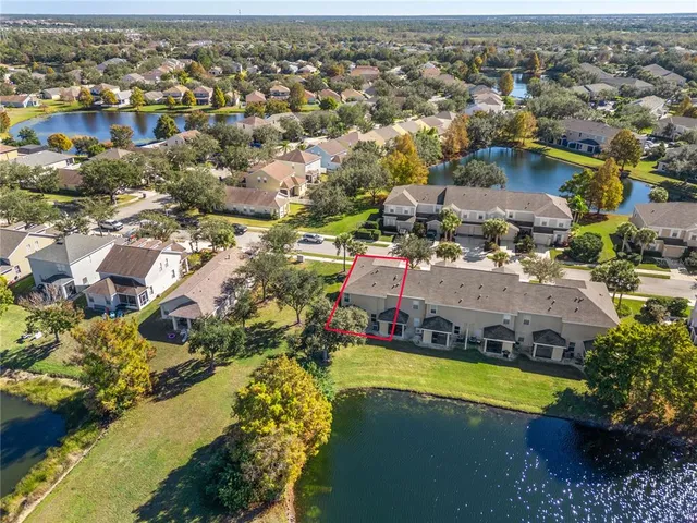 an aerial view of a house with a lake view