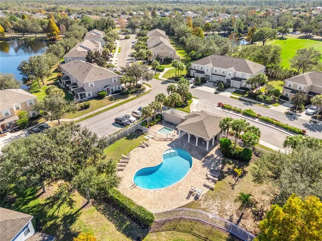 an aerial view of residential houses with outdoor space