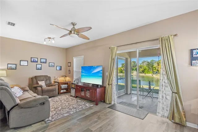 a living room with furniture a window and a flat screen tv