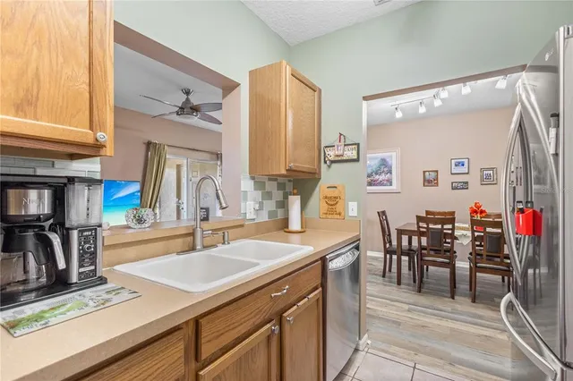 a kitchen with sink refrigerator and cabinets