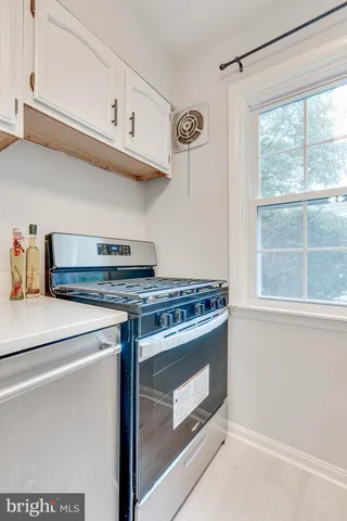 a stove top oven sitting inside of a kitchen