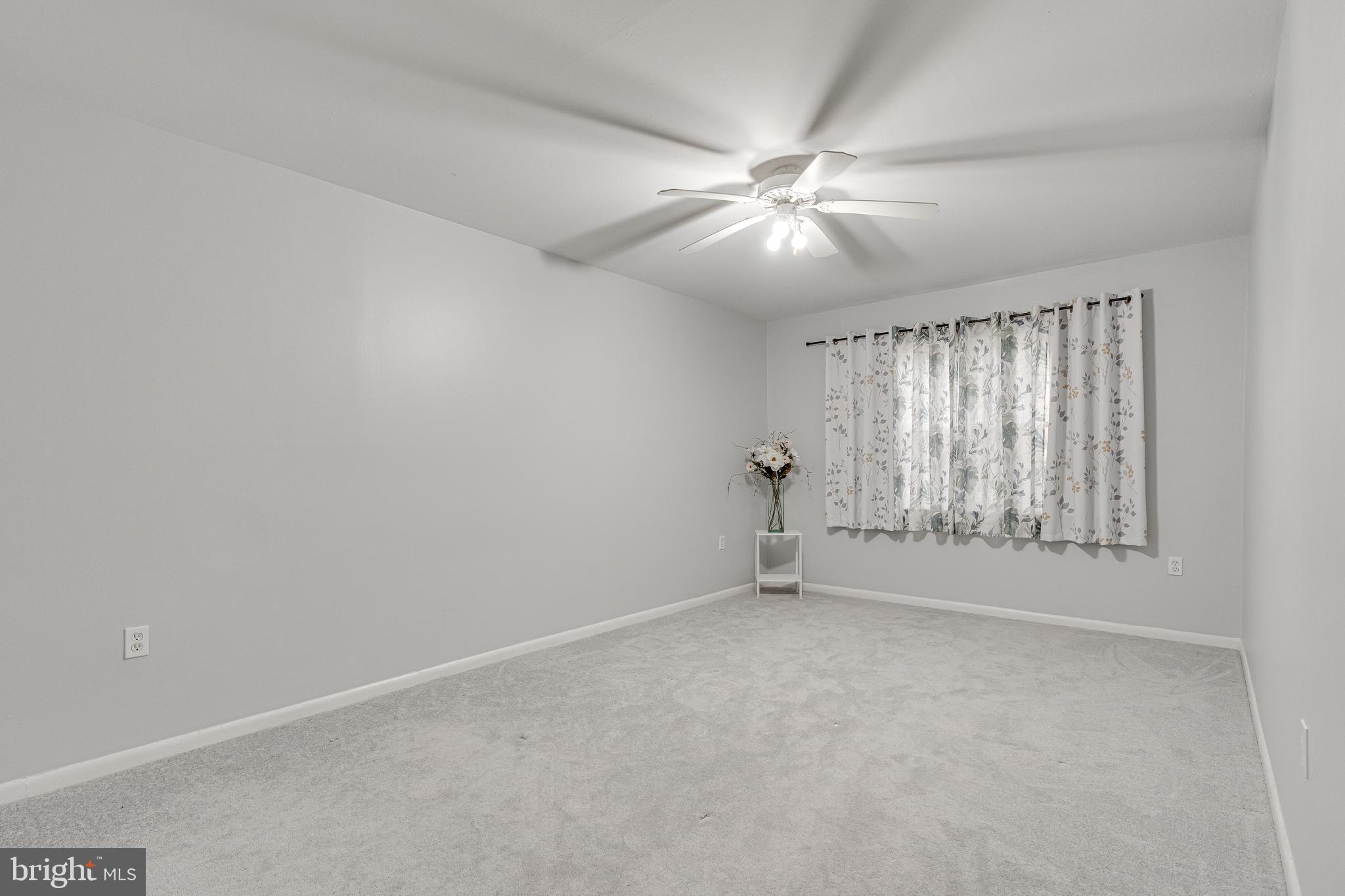 9473 Fairfax Boulevard, Unit 104 Fairfax, VA 22031 - Photo 13 of 32 an empty room with windows and fan