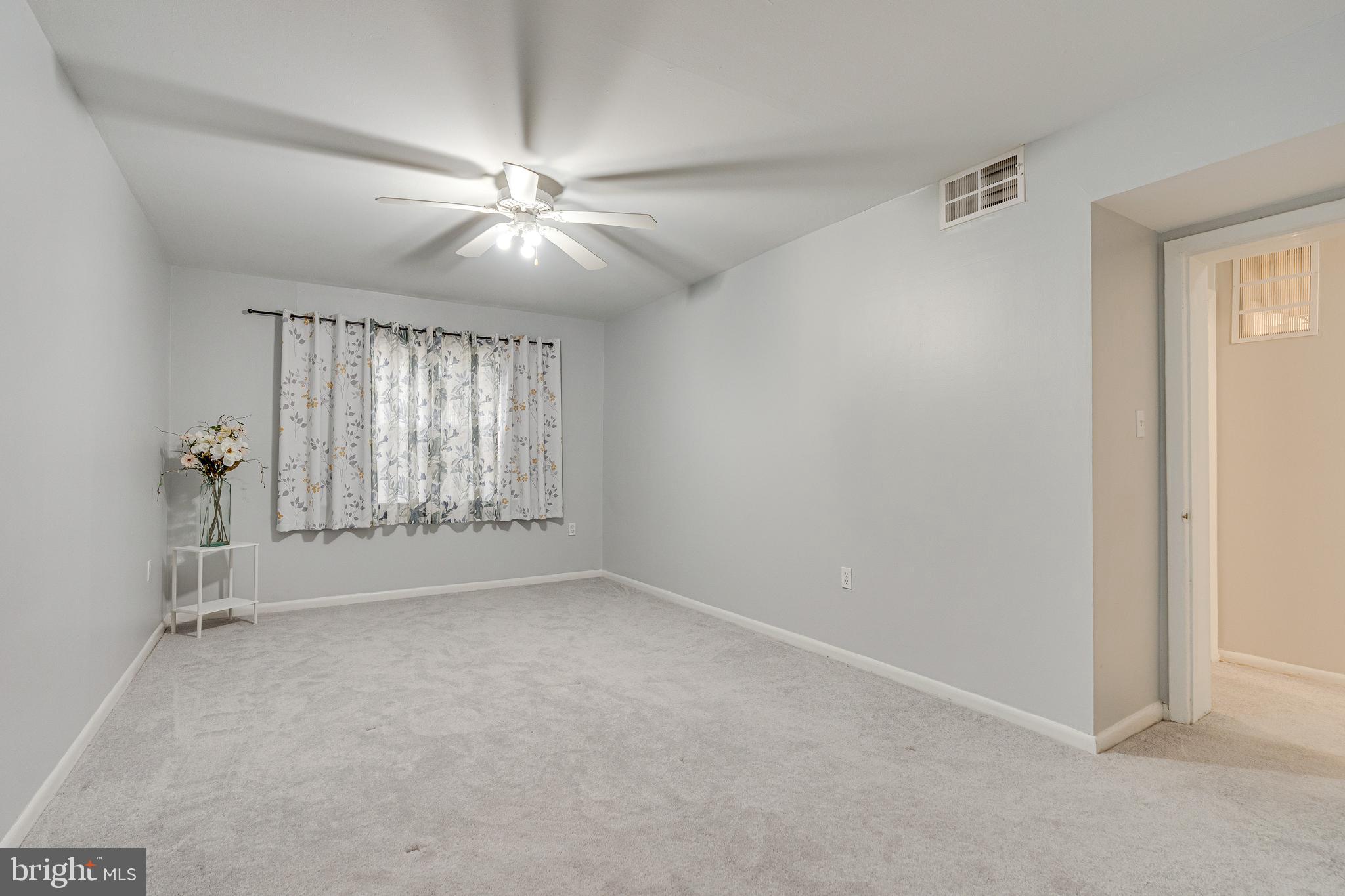9473 Fairfax Boulevard, Unit 104 Fairfax, VA 22031 - Photo 14 of 32 an empty room with windows and fan