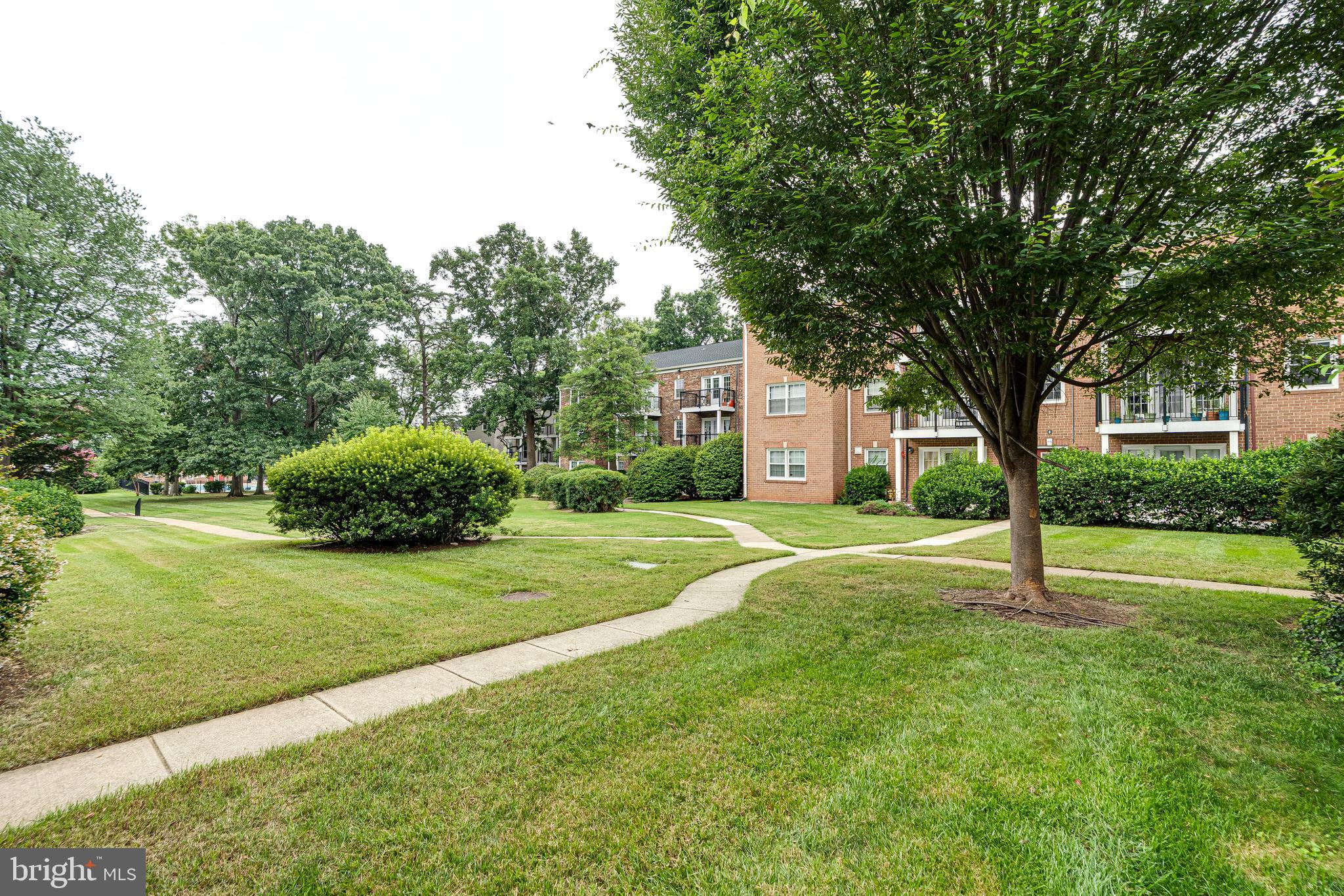 9473 Fairfax Boulevard, Unit 104 Fairfax, VA 22031 - Photo 26 of 32 a house with trees in the background