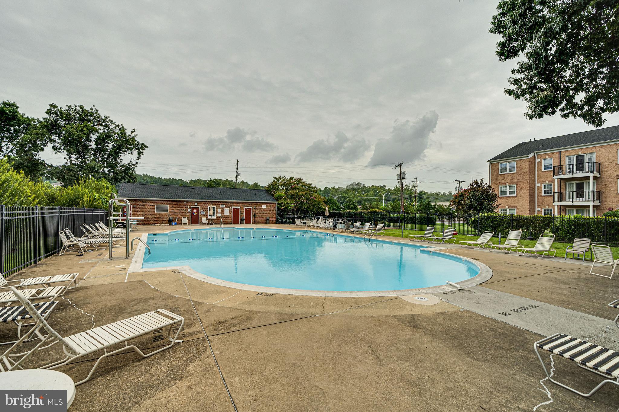 9473 Fairfax Boulevard, Unit 104 Fairfax, VA 22031 - Photo 28 of 32 a view of a swimming pool with an outdoor seating