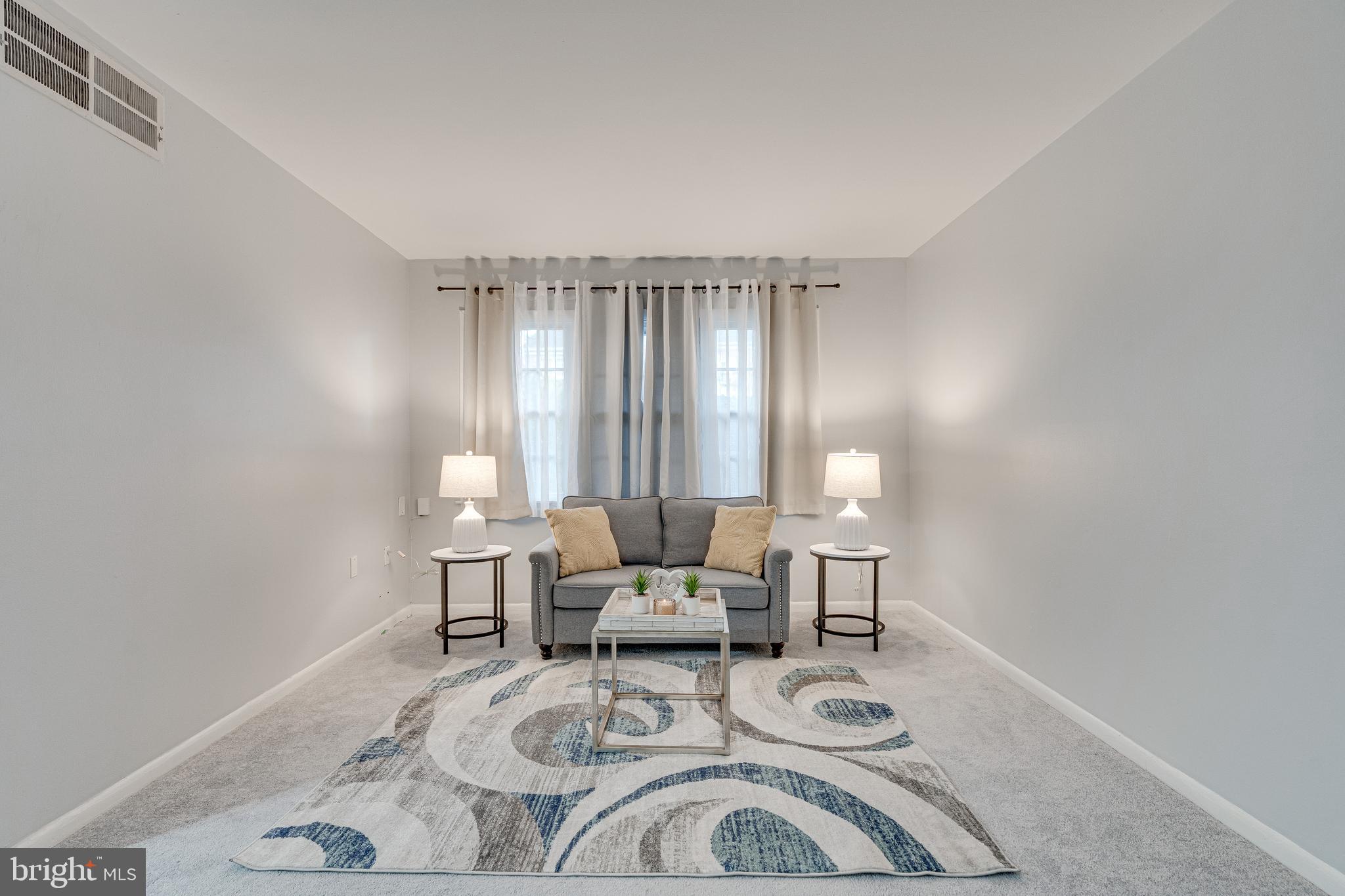 9473 Fairfax Boulevard, Unit 104 Fairfax, VA 22031 - Photo 5 of 32 a living room with furniture and window