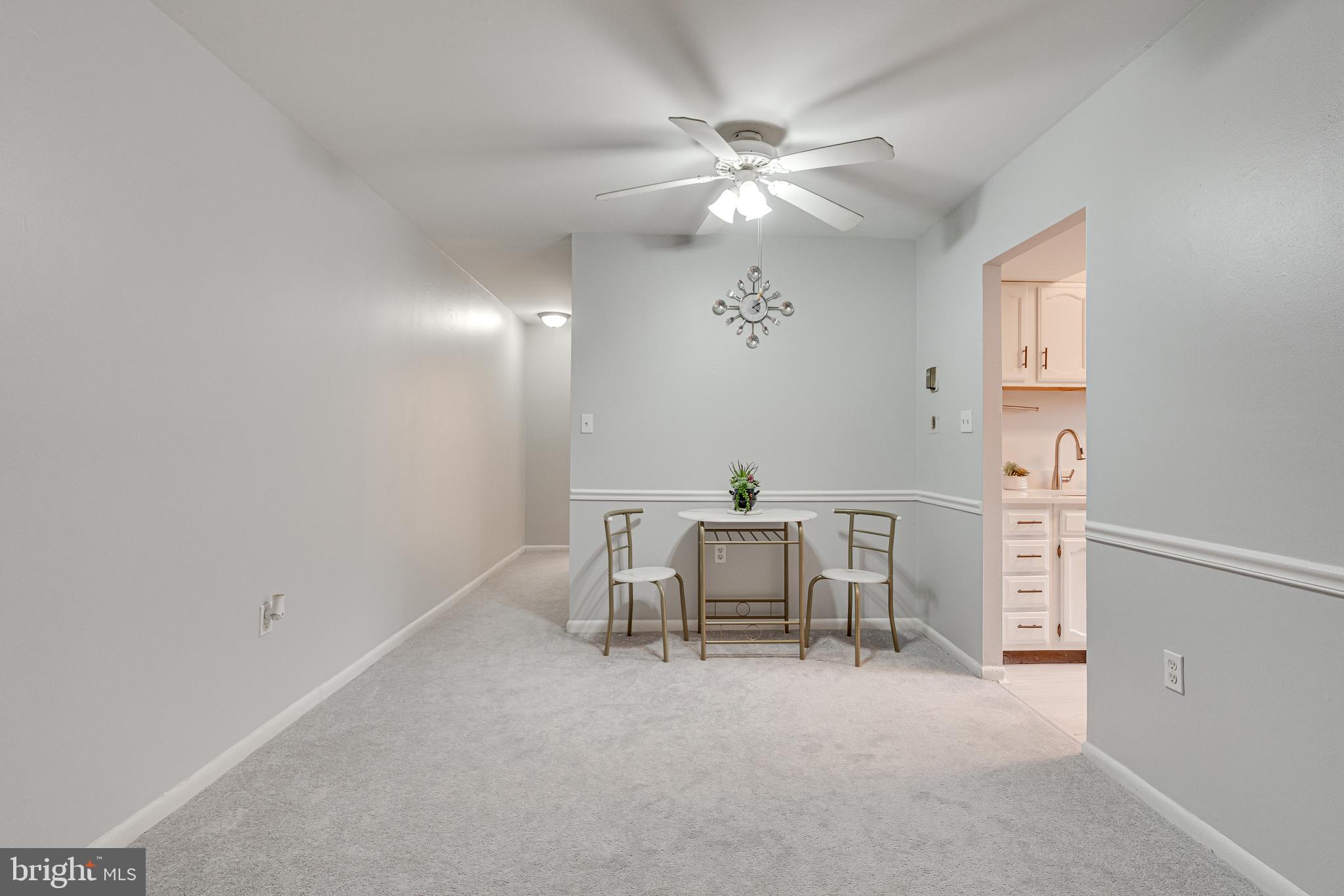 9473 Fairfax Boulevard, Unit 104 Fairfax, VA 22031 - Photo 7 of 32 an empty room with windows and fan