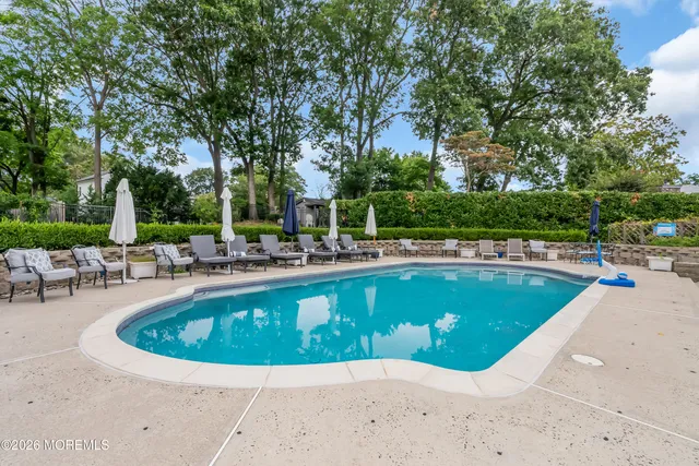 a view of a swimming pool with chairs in patio