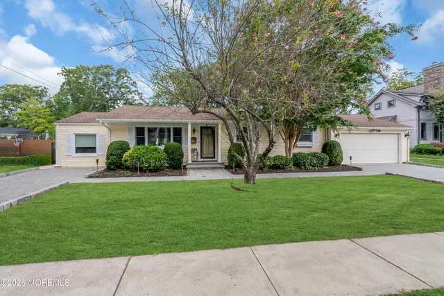 a kitchen with stainless steel appliances granite countertop a refrigerator a stove and a sink with wooden cabinets