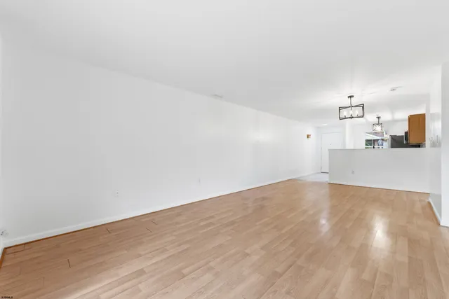 a view of a kitchen with wooden floor and a sink