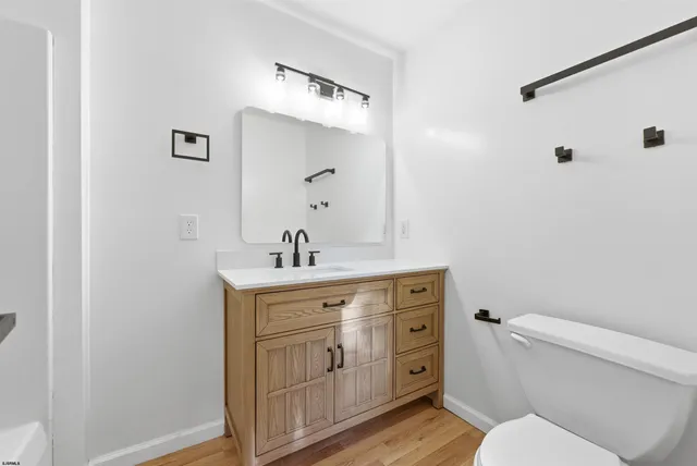 a bathroom with a toilet a sink and mirror
