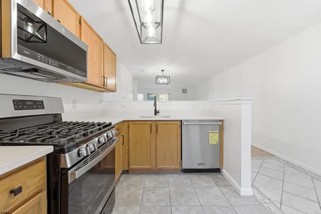 a kitchen with stainless steel appliances granite countertop a stove and a sink