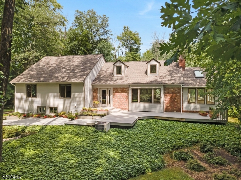 28 Skyline Drive Warren, NJ 07059 - Photo 1 of 34 a front view of a house with garden and trees